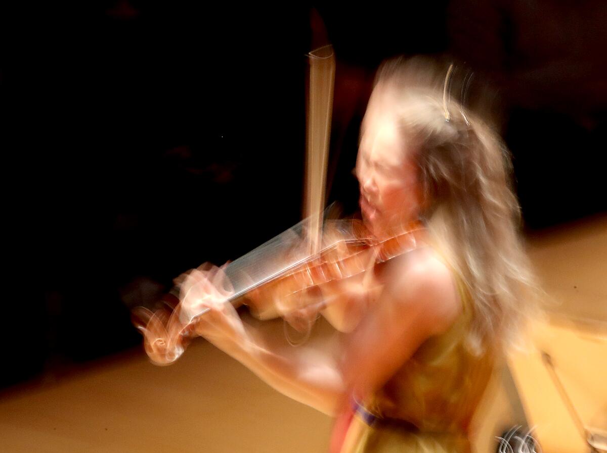 A violinist is a blur as she performs.