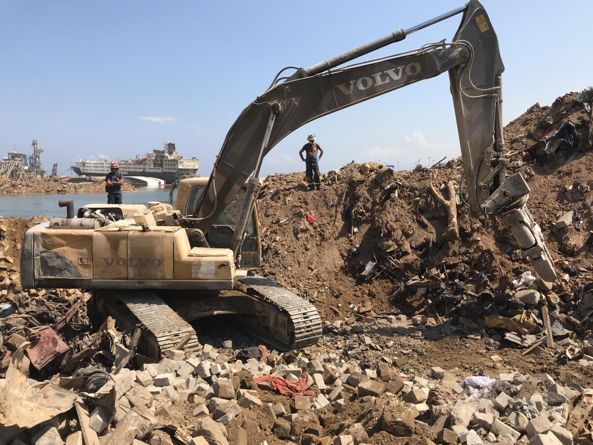An excavator sifts through the rubble in Beirut's ravaged port.