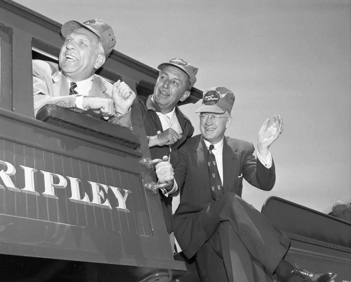 From left, California Gov. Goodwin Knight, Walt Disney and Fred G. Gurley, president of the Atcheson, Topeka and Santa Fe Railway, aboard the Santa Fe & Disneyland Railroad at the opening of the theme park in 1955.