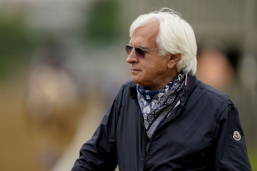 FILE - In this April 28, 2021, file photo, horse trainer Bob Baffert watches workouts at Churchill Downs.