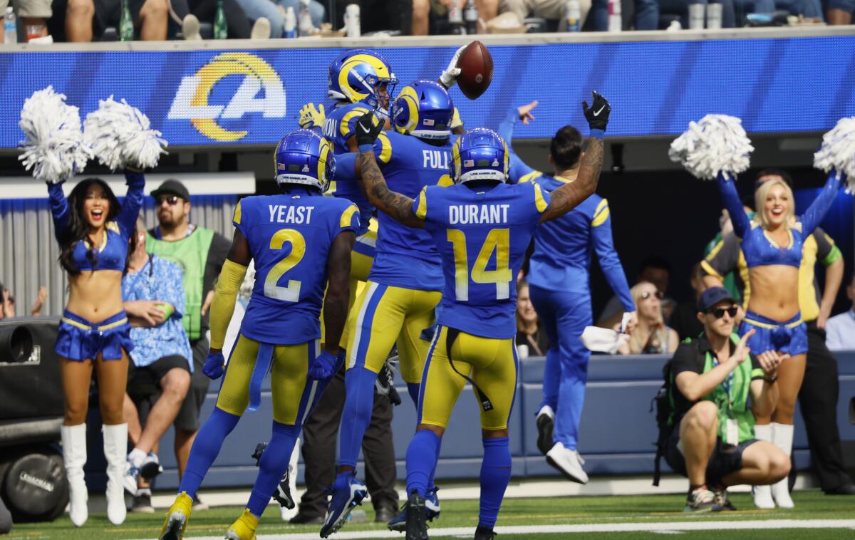 Rams cornerback Ahkello Witherspoon celebrates with teammates after intercepting a pass.