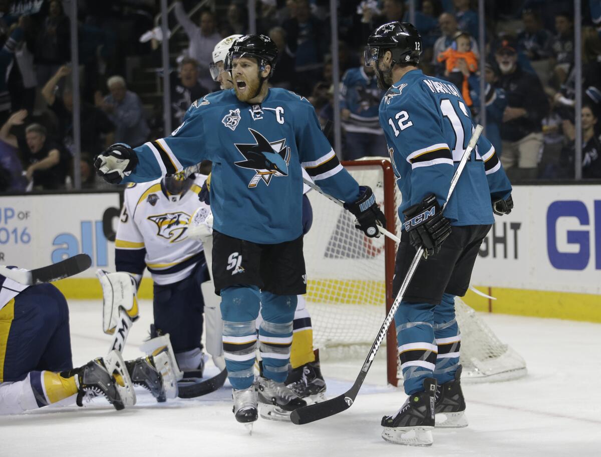 Sharks center Joe Pavelski (8) celebrates with teammate Patrick Marleau (12) after scoring in the first period of Game 7.