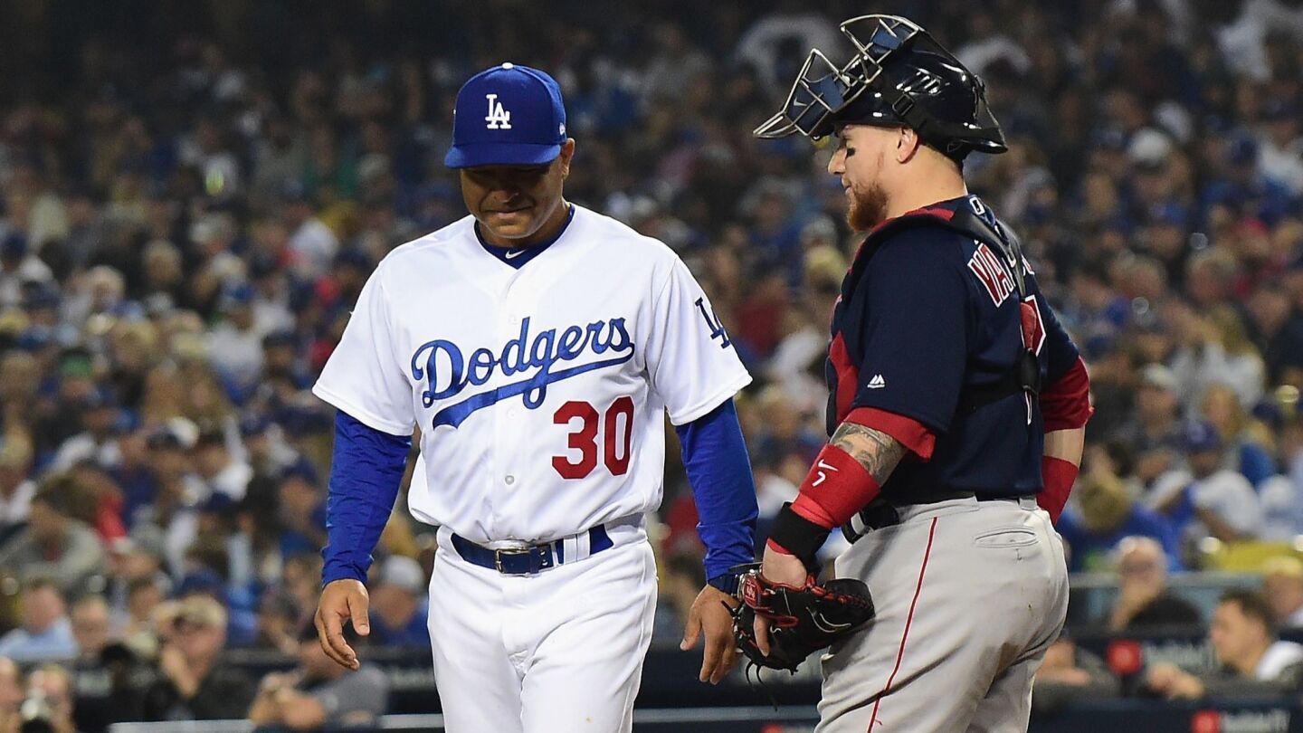 LOS ANGELES, CA - OCTOBER 27: Catcher Christian Vazquez #7 of the Boston Red Sox looks on as manager Dave Roberts #30 of the Los Angeles Dodgers walks by during the fourth inning of Game Four of the 2018 World Series at Dodger Stadium on October 27, 2018 in Los Angeles, California. (Photo by Harry How/Getty Images) ** OUTS - ELSENT, FPG, CM - OUTS * NM, PH, VA if sourced by CT, LA or MoD **