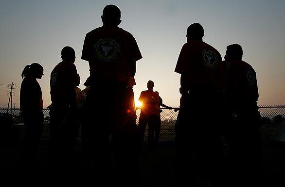 Firefighters from the Northern Cheyenne Initial Attack Crew in Montana hold a morning meeting at Hansen Dam Park.