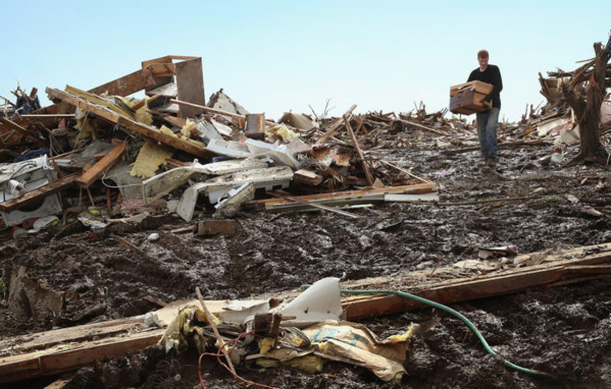 Matt Johnson salvages items from his grandparent's Moore, Okla., home after a powerful tornado ripped through the neighborhood.
