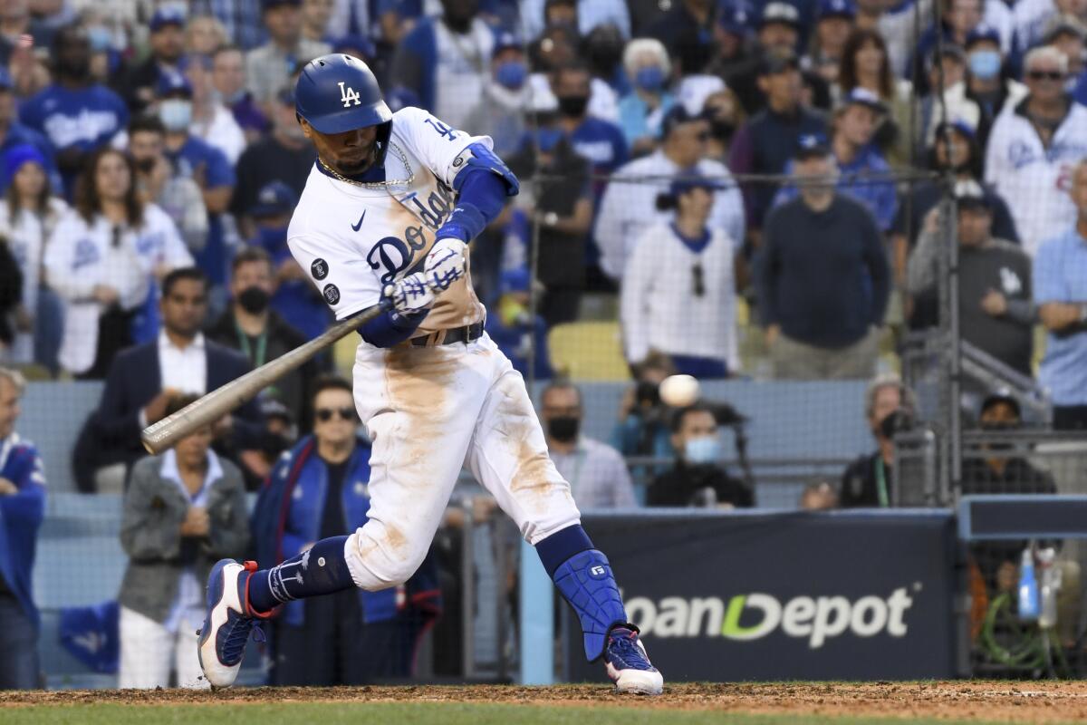 Dodgers' Mookie Betts hits a go-ahead RBI double during the eighth inning in Game 3 in the 2021 NLCS.