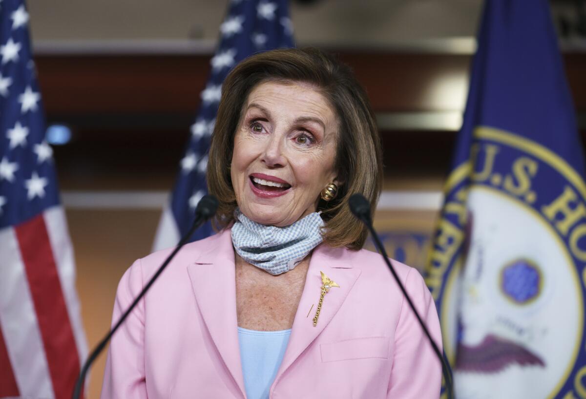 Looking cheerful, Speaker Nancy Pelosi takes questions from reporters 
