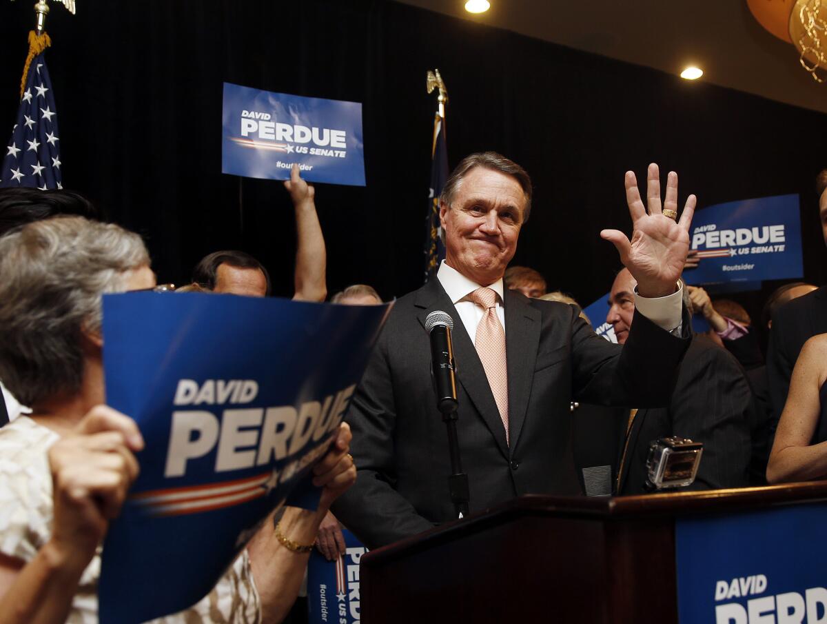 David Perdue waves to supporters after declaring victory Tuesday in the Republican primary runoff for a U.S. Senate seat from Georgia.