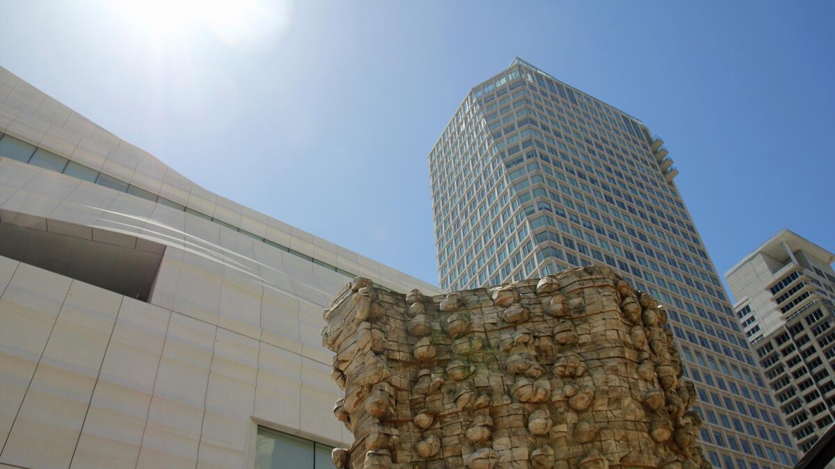 A view of Ursula von Rydingsvard's 2006 sculpture "Czara z Babelkami" blends in with the upward view of the San Francisco skyline from the museum's rooftop sculpture garden.