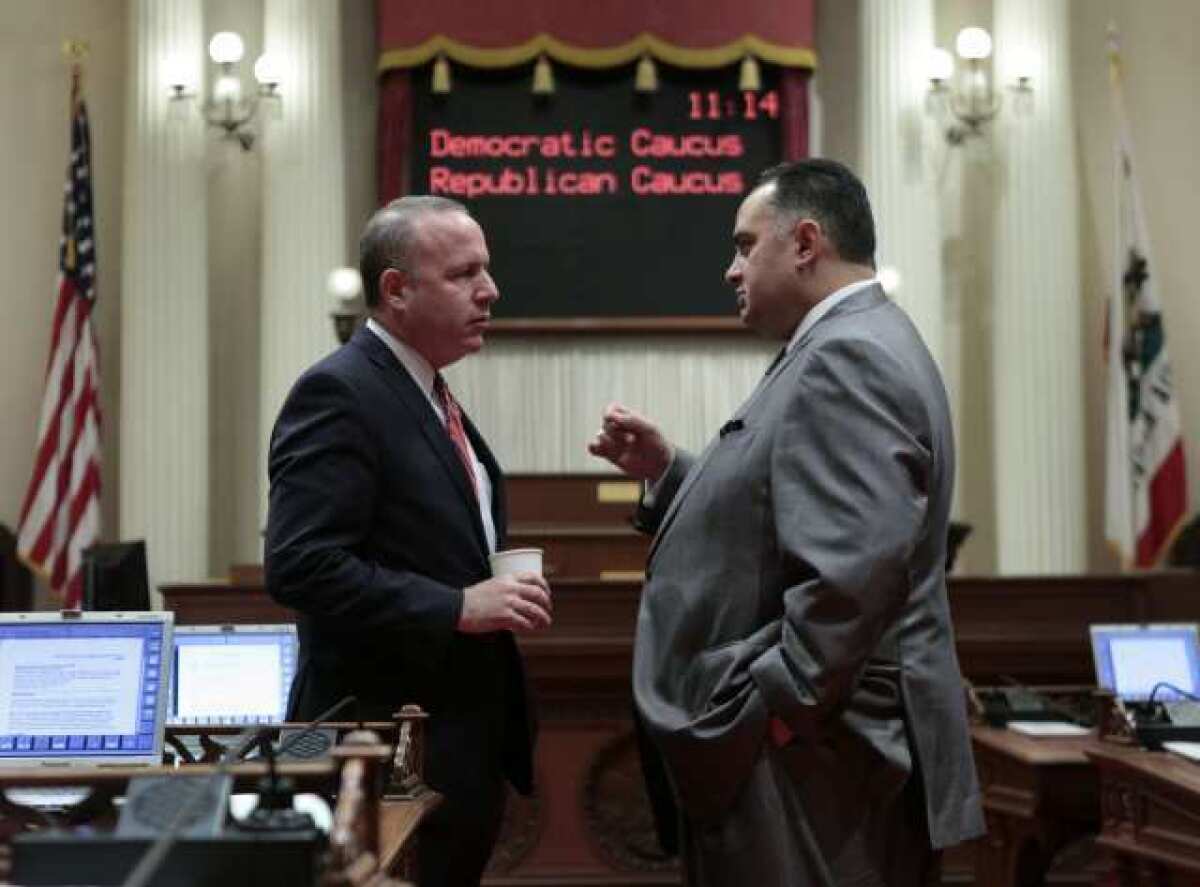 Senate leader Darrell Steinberg (D-Sacramento), left, confers with Assembly Speaker John Perez (D-Los Angeles) in the Capitol last year.