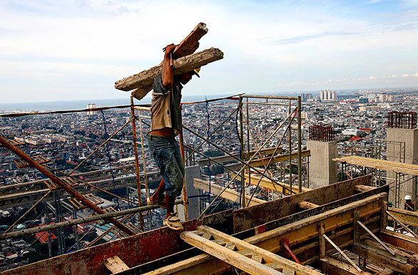 A worker at an apartment construction site Wednesday. The Indonesian finance minister said that Indonesia's economic growth in the first quarter of 2010 was expected to reach 5.7%, a media report said.