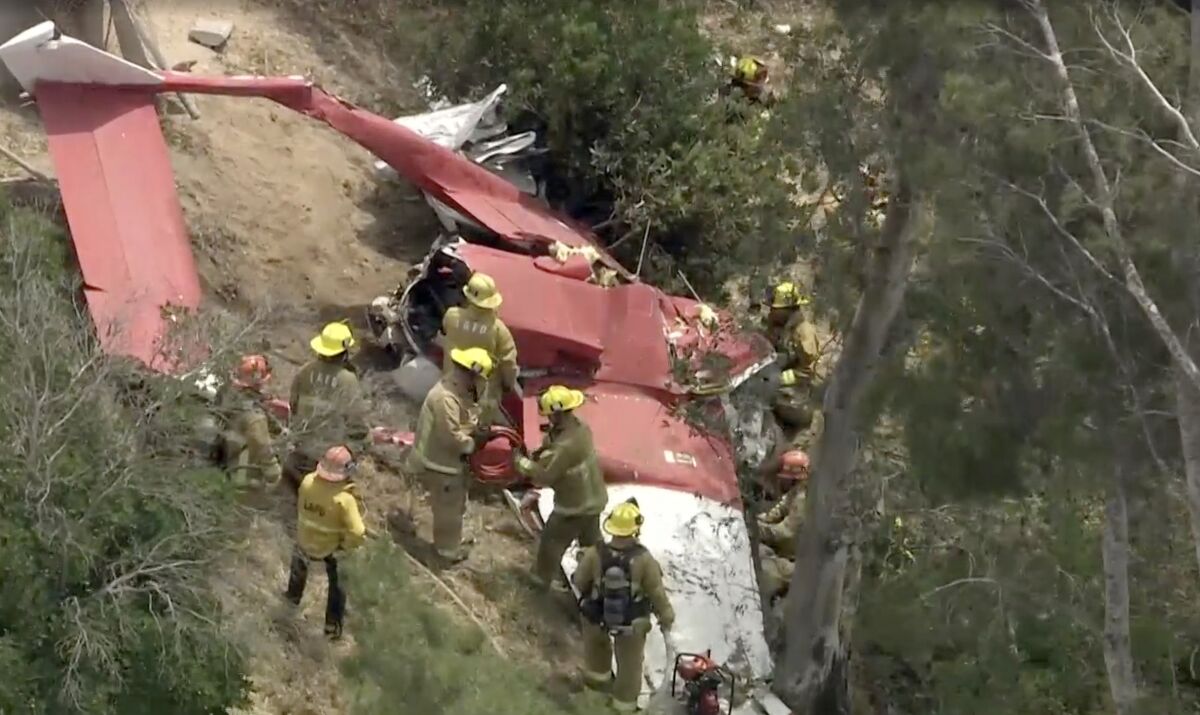 Authorities respond to a downed plane near the 210 Freeway in Sylmar on April 20, 2022.