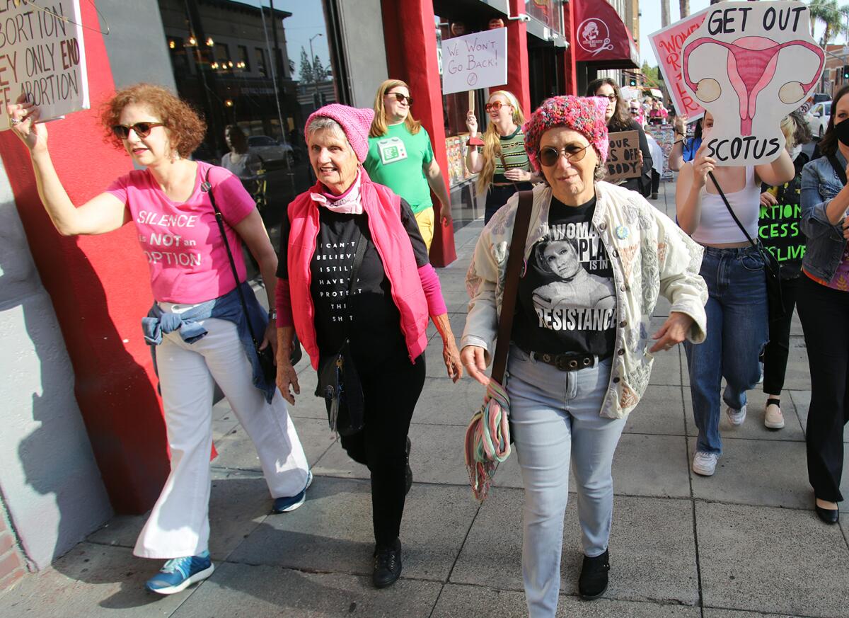 Mary Carter of Laguna Beach, second from left, walks with with local abortion rights advocates at the Santa Ana rally.