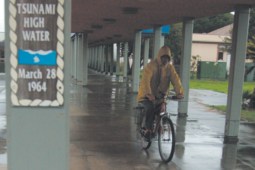 A man rides his bicycle in 2004 in Crescent City, where a 1964 earthquake spawned a deadly tsunami.
