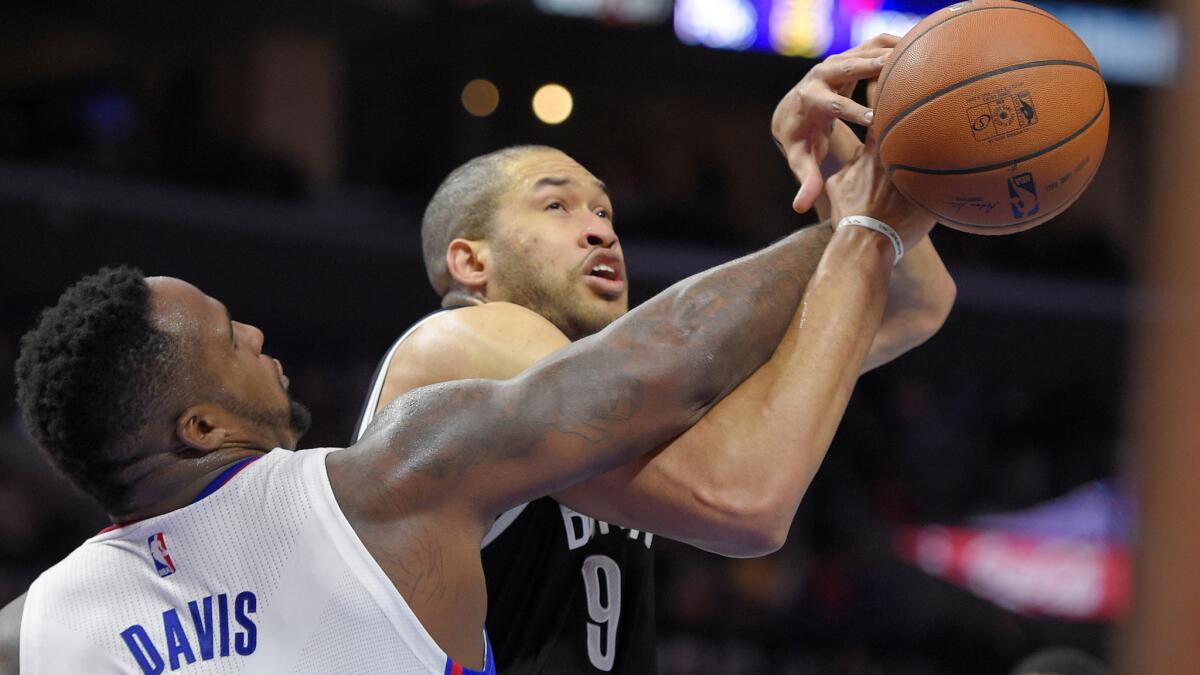 Clippers forward Glen Davis, left, fouls Brooklyn Nets center Jerome Jordan during the Clippers' win at Staples Center on Jan. 22.