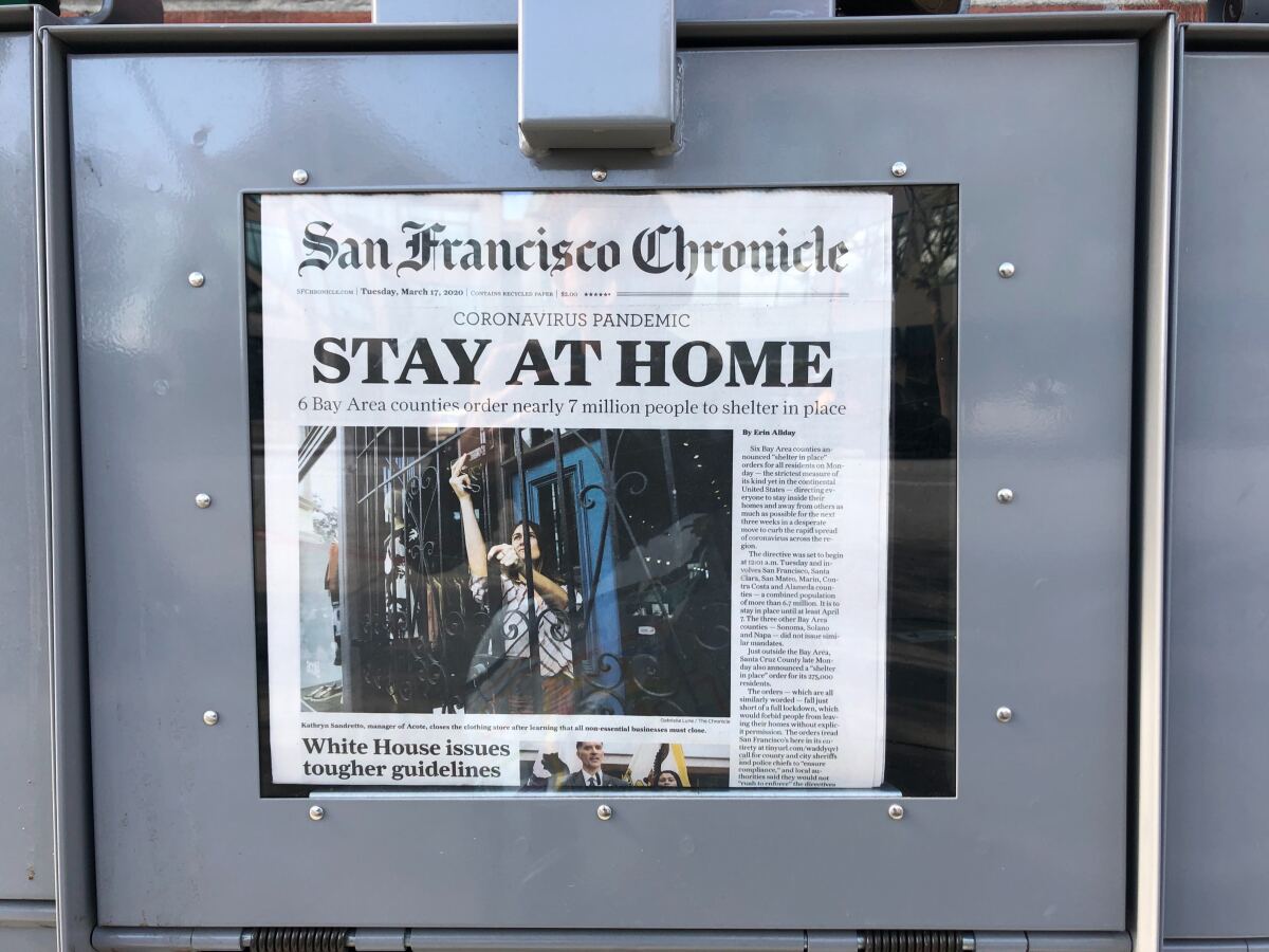 A newsstand displays the front page of the San Francisco Chronicle on Tuesday, March 17, 2020. 