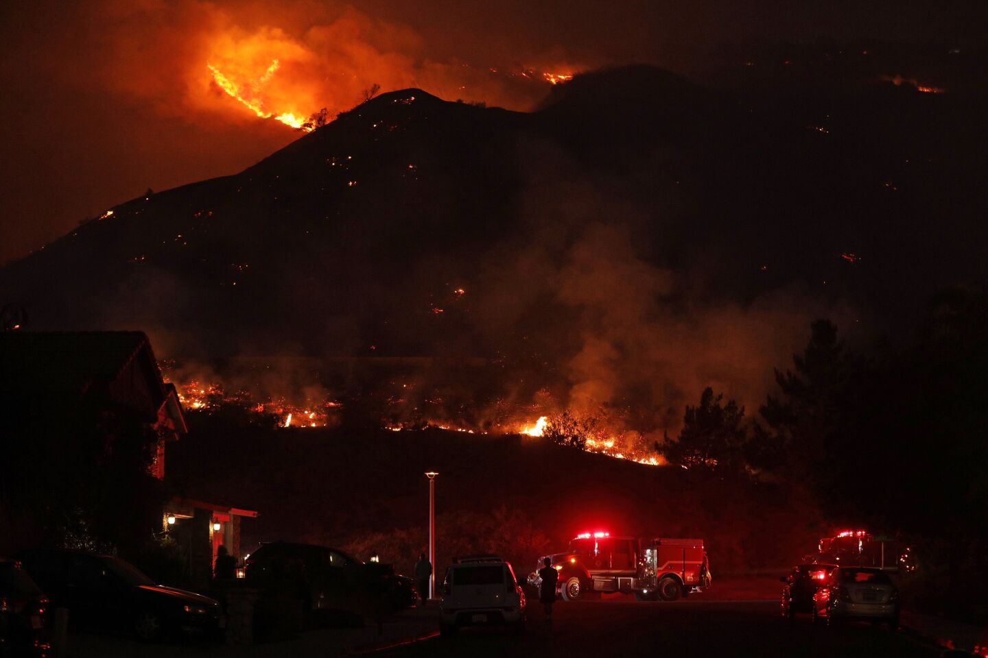 A hillside is dotted with flames
