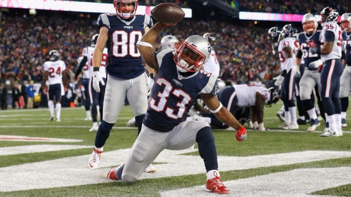 Patriots running back Dion Lewis celebrates after scoring a touchdown against the Texans during a game on Jan. 14.