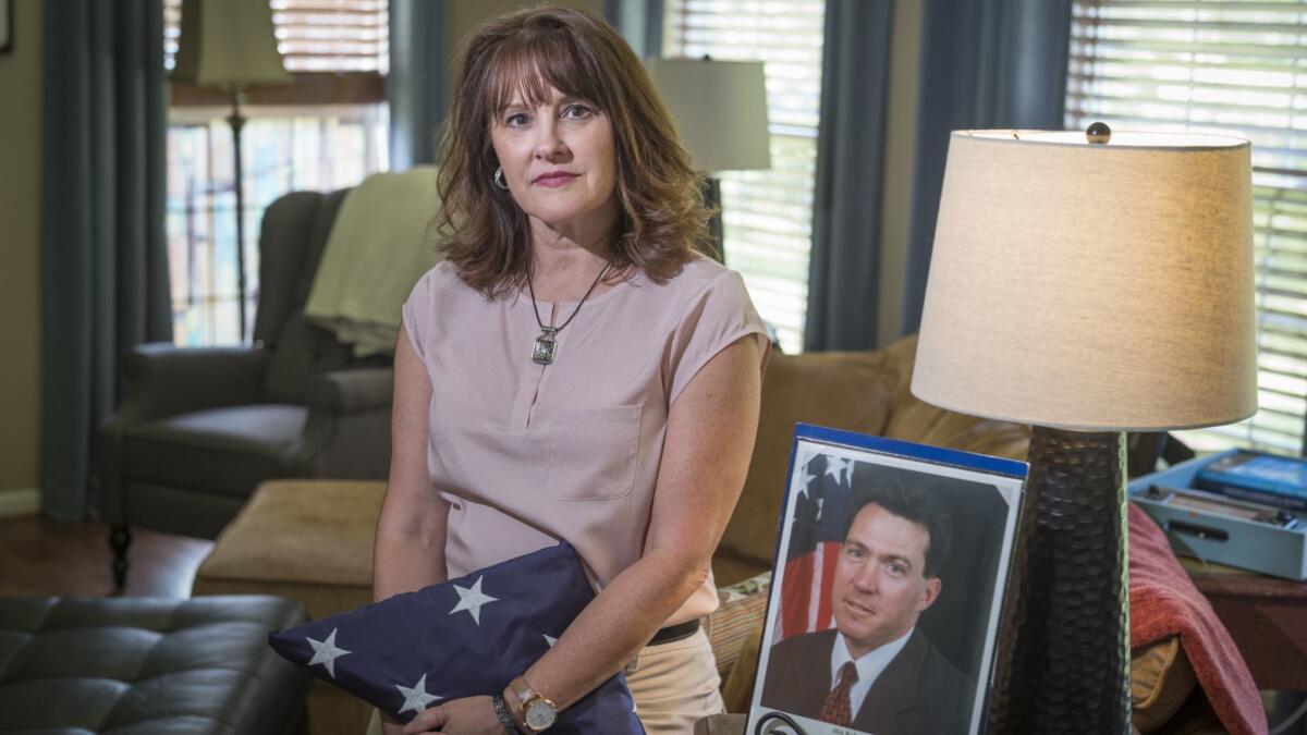 Tresa Roth, whose husband, FBI Agent Robert Roth, died from cancer in 2008, with memorabilia from his time at the agency. He assisted rescue and investigative efforts at the Pentagon after the Sept. 11 attacks in 2001.