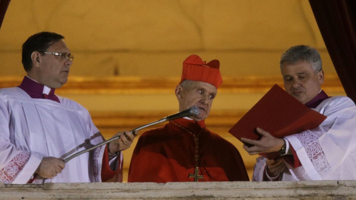 Cardinal Jean-Louis Tauran, center, announces the election of of Pope Francis from the central balcony of St. Peter's Basilica at the Vatican in 2013.