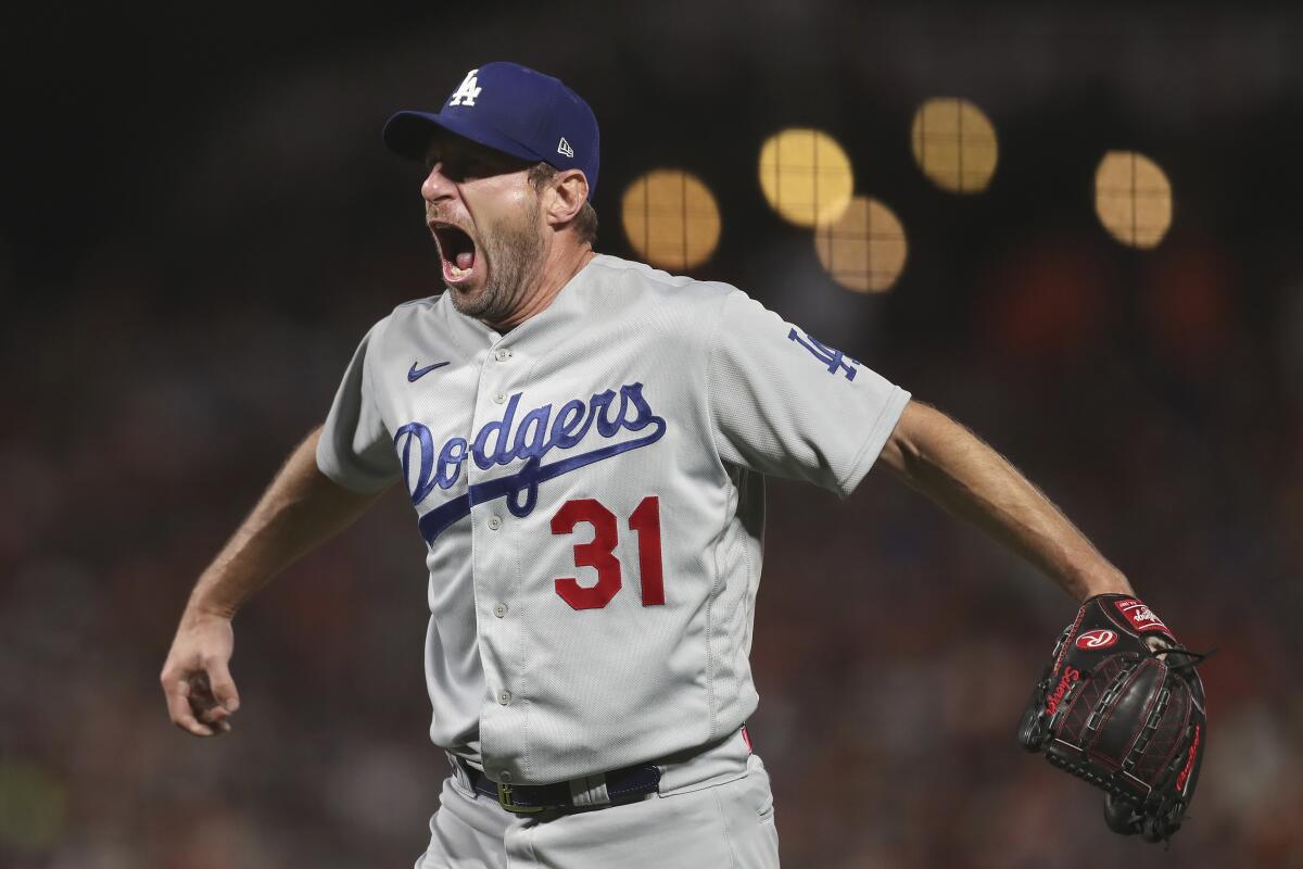 Dodgers pitcher Max Scherzer celebrates after the team defeated the Giants in Game 5 of the NLDS 