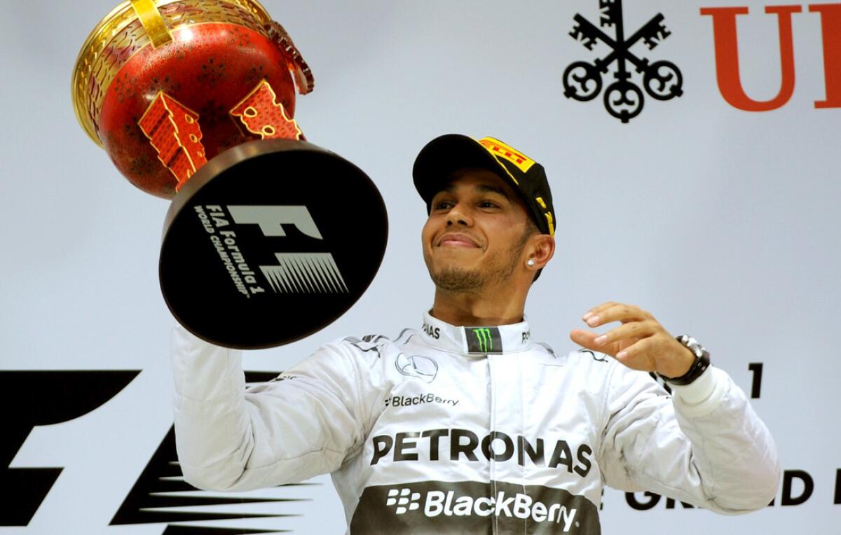 Formula One driver Lewis Hamilton lifts the winner's trophy at the Chinese Grand Prix in Shanghai on Sunday.