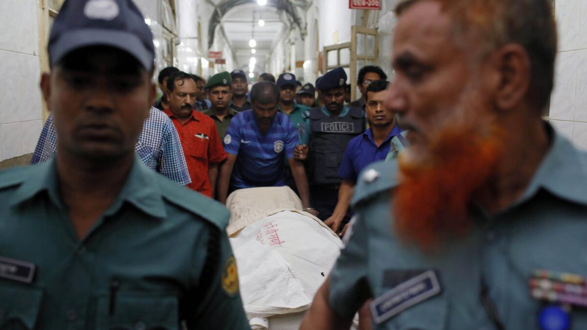 Authorities with the body of Faisal Arefin Deepan, a secular publisher killed in a 2015 machete attack at his office.