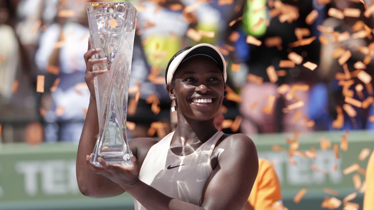 Sloane Stephens poses with the winner's trophy after capturing the Miami Open title on Saturday.