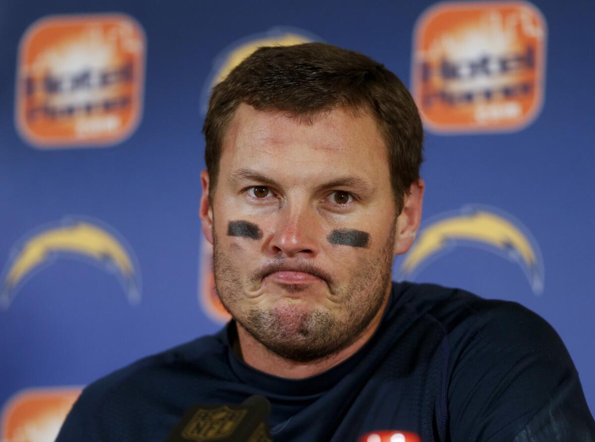 San Diego quarterback Philip Rivers talks after a loss to Denver on Jan. 3.