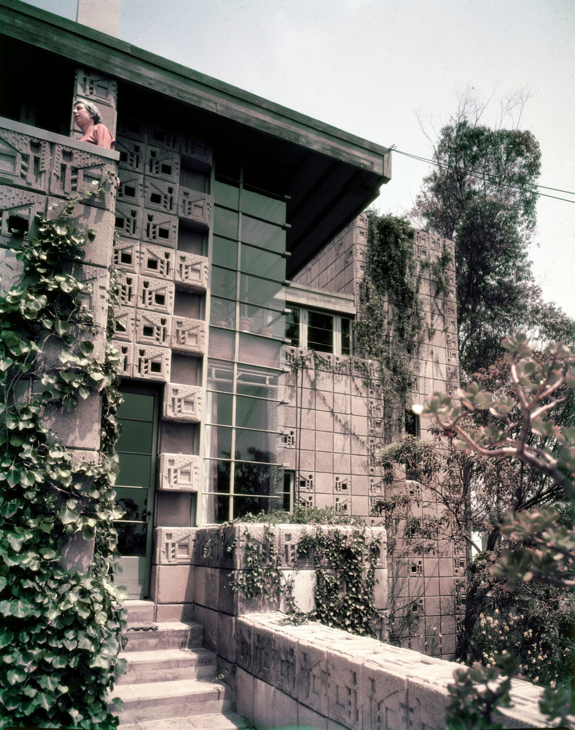 A color image from the 1950s shows the textile blocks and corner windows of the Freeman House's front facade.