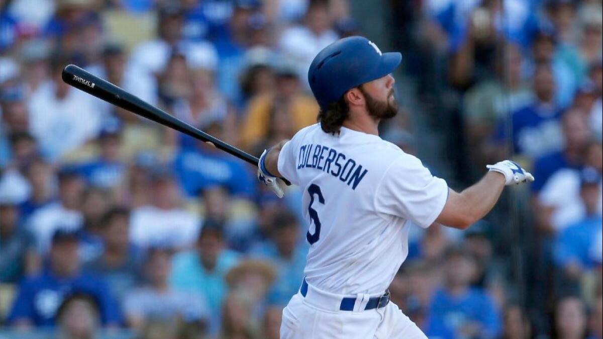 Dodgers seond baseman Charlie Culberson watches the trajectory of walk-off home run against the Rockies in the tenth inning of a game on Sept. 25.