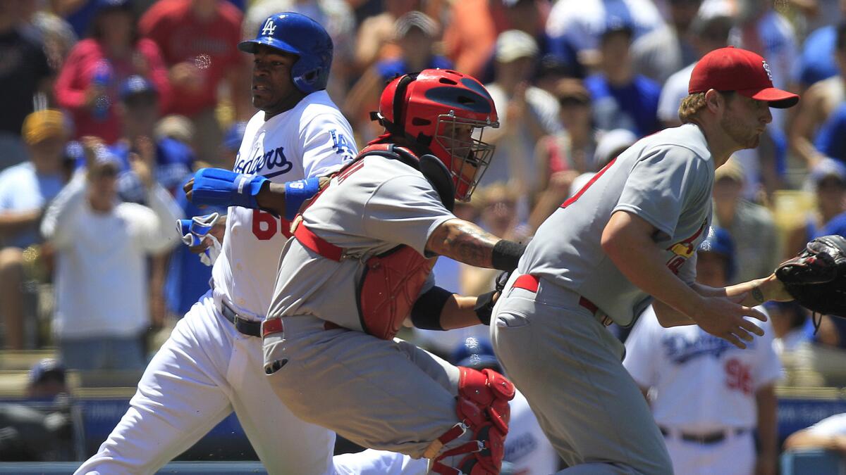Dodgers right fielder Yasiel Puig, left, scores past St. Louis catcher Yadier Molina, center, and starting pitcher Shelby Miller during the Dodgers' 6-0 win Sunday.