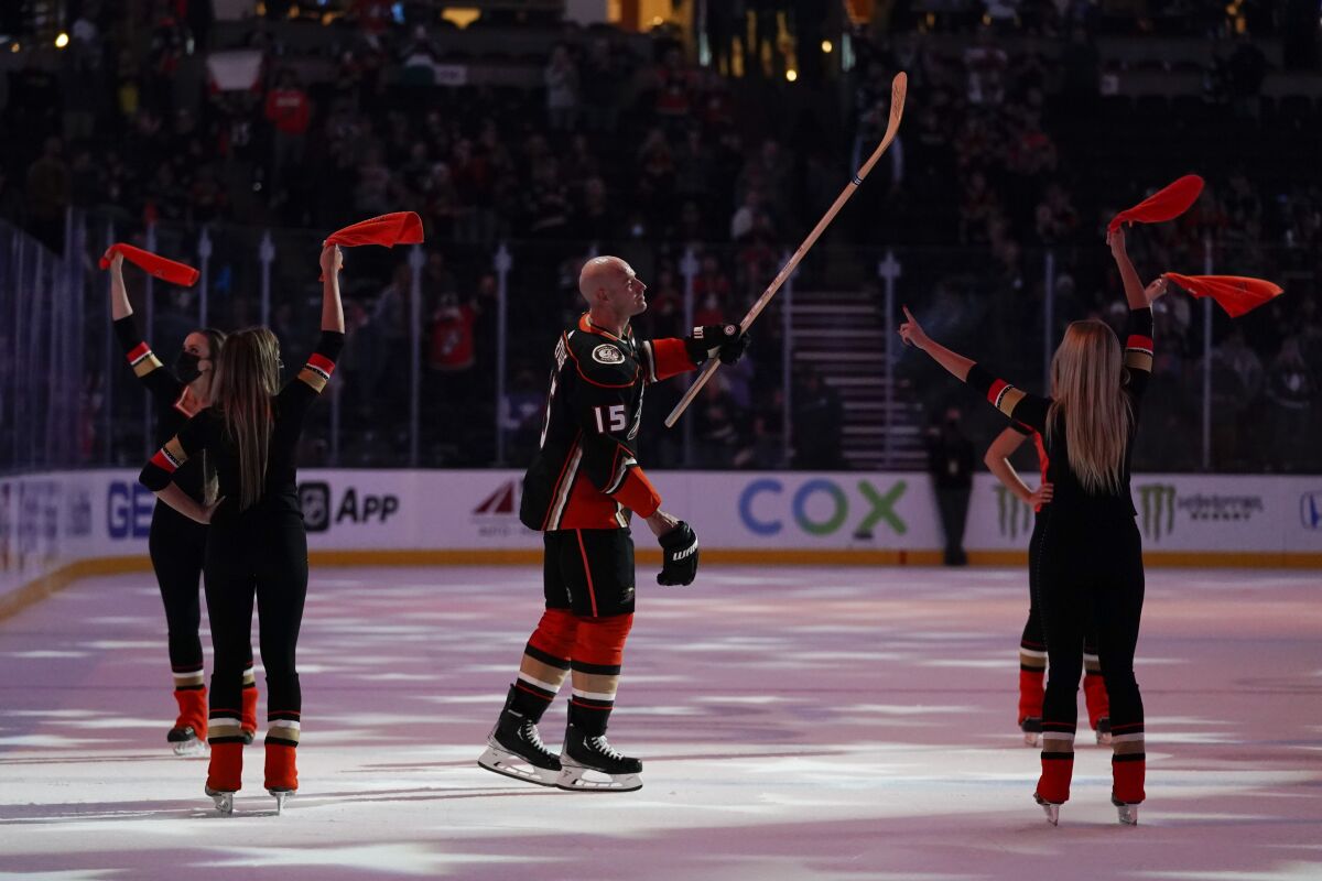 Ducks' Ryan Getzlaf (15) is honored after a win, during which scored his 1,000th goal. (AP Photo/Ashley Landis)