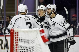 Los Angeles Kings' Trevor Moore, center, celebrates after his goal with teammates.