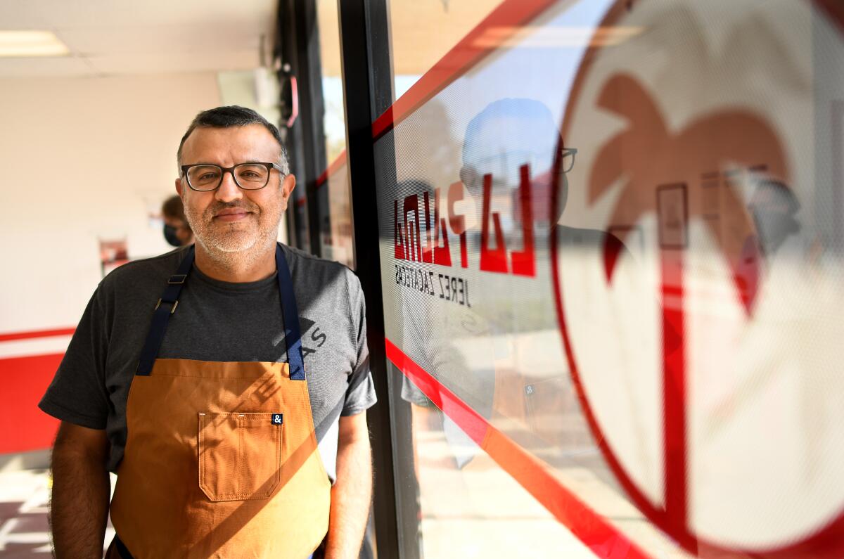 Albert Bañuelos stands inside his store, Burritos La Palma