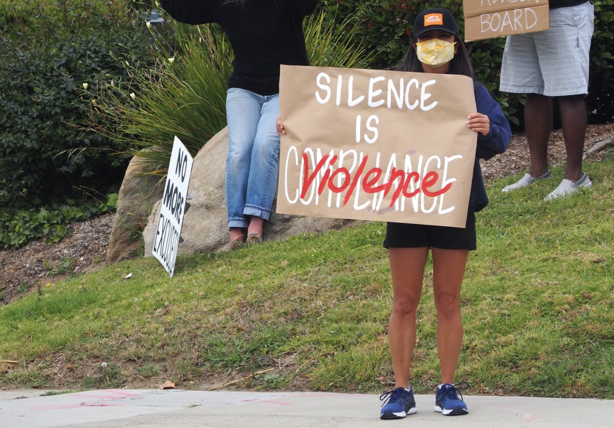 A protestor in front of the San Dieguito district office.