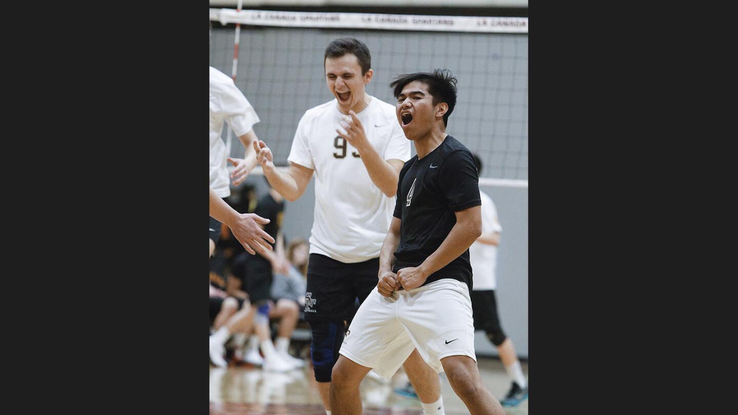 St. Francis' Valentin Medina and Coby Escolano scream out to celebrate victory over La Canada in a non-league boys' volleyball match at La Canada High School on Thursday, March 15, 2018. St. Francis won the match 3-0.