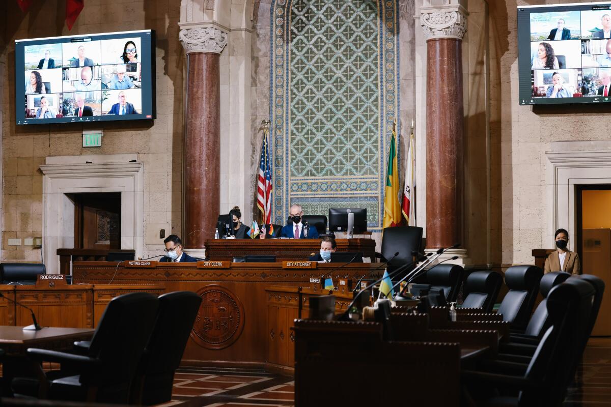 The near-empty council chambers with a big Zoom screen up on the wall.