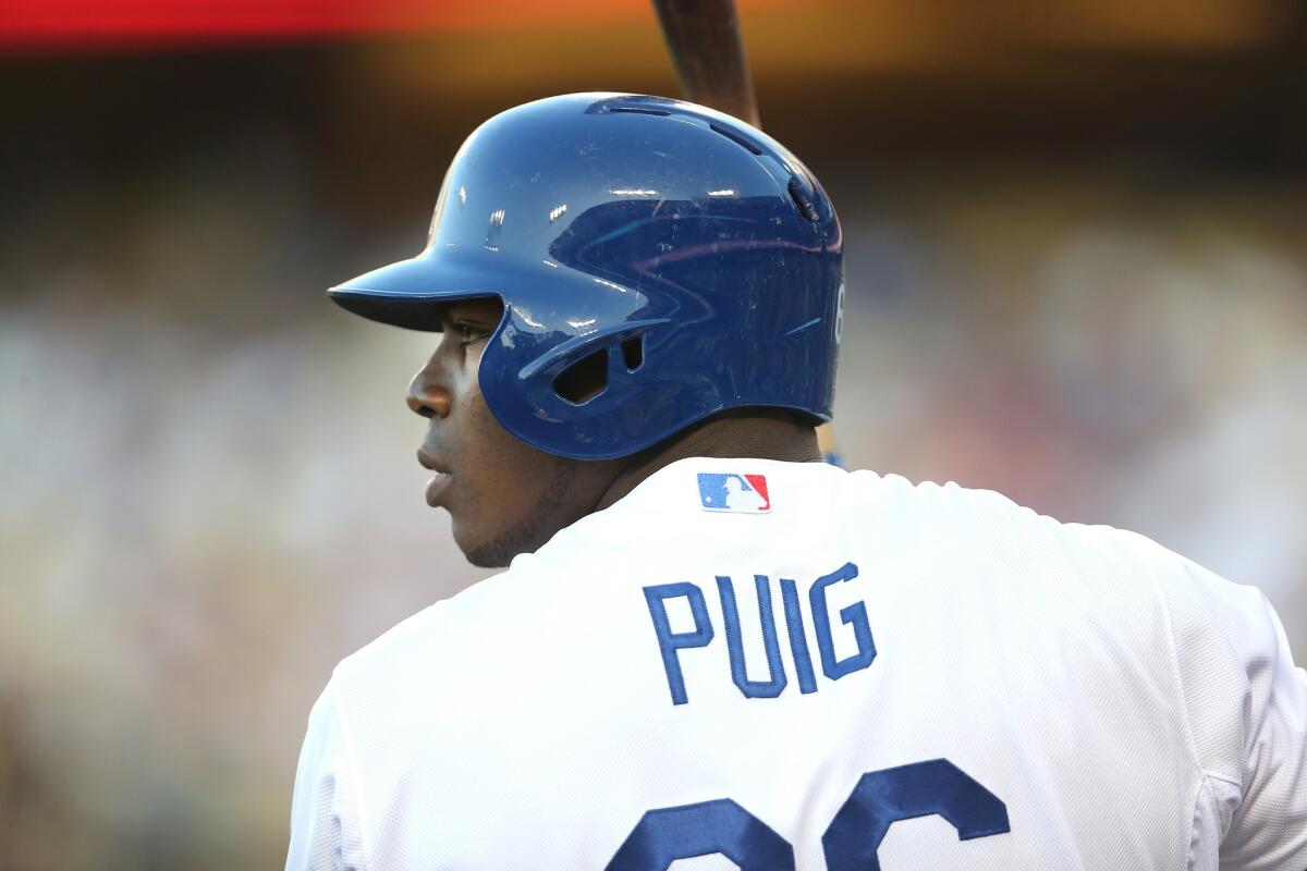 Dodgers outfielder Yasiel Puig waits for his turn at the plate during the first inning of a game Thursday against the Texas Rangers at Dodger Stadium.