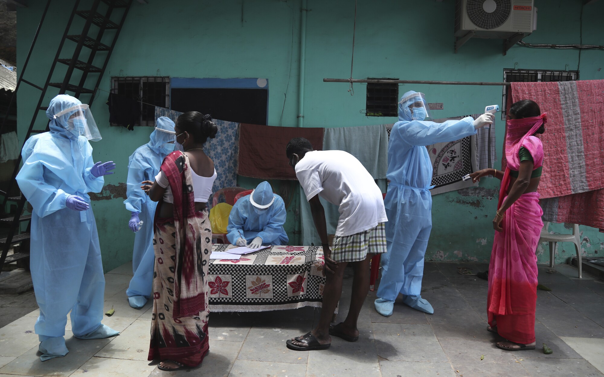 Doctors conduct a free medical camp in Dharavi, a slum in Mumbai, India.