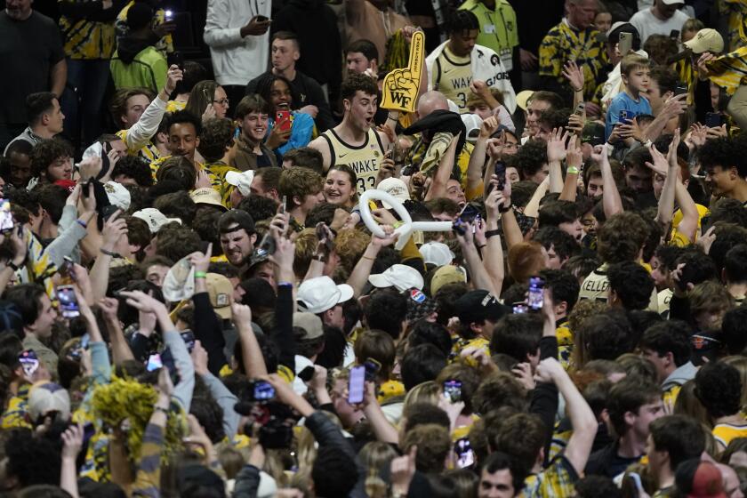 Wake Forest's Matthew Marsh (33) celebrates with fans after Wake Forest's win over Duke in an NCAA college basketball game in Winston-Salem, N.C., Saturday, Feb. 24, 2024. (AP Photo/Chuck Burton)