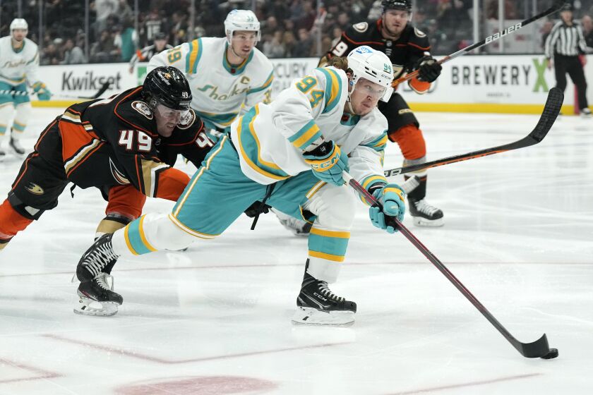 San Jose Sharks left wing Alexander Barabanov, right, moves the puck as Anaheim Ducks left wing Max Jones defends during the first period of an NHL hockey game Friday, Dec. 9, 2022, in Anaheim, Calif. (AP Photo/Mark J. Terrill)