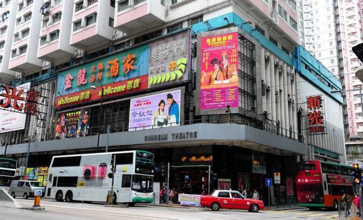 Traffic passes in front of the Sunbeam theater, a location famous for showing Cantonese Opera and which is about to be closed, in Hong Kong.