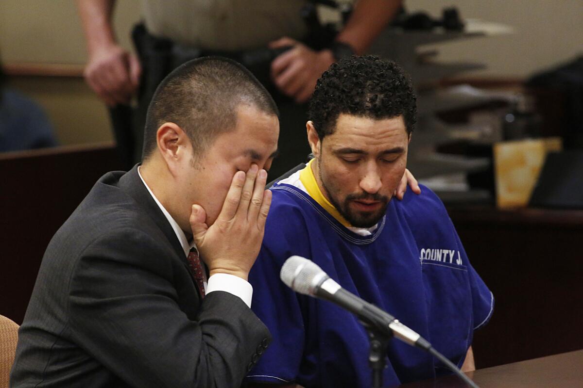 Alex Donald Jackson, right, reacts with his defense attorney Al Kim as Jackson's brother pleads for leniency during his sentencing for the second degree murder of Pamela Devitt. Jackson's pit bulls mauled to death 63-year-old Pamela Devitt in May 2013.