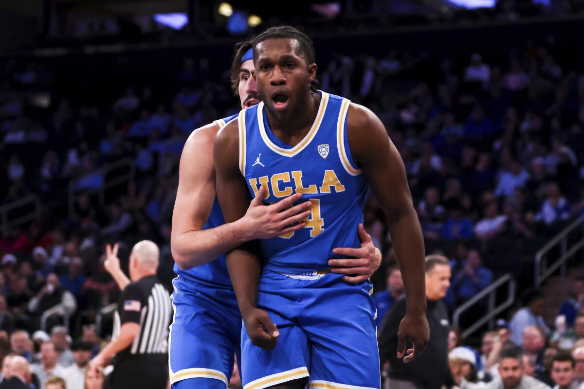 UCLA guard Jaime Jaquez Jr. holds back UCLA guard David Singleton as he reacts during the first half against Kentucky.