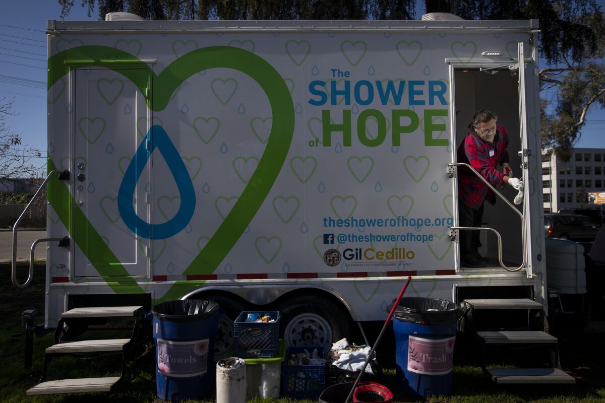 Volunteer Daniel Monreal, 58, cleans the showers at Lincoln Park in the Lincoln Heights neighborhood of Los Angeles. Monreal is a plumber on leave because of the cornavirus epidemic. Shower of Hope provides showers for homeless people.