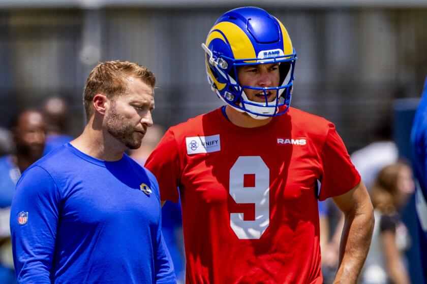 IRVNE, CA - JULY 24, 2022: Rams coach Sean McVay calls confers with quarterback Matthew Stafford.