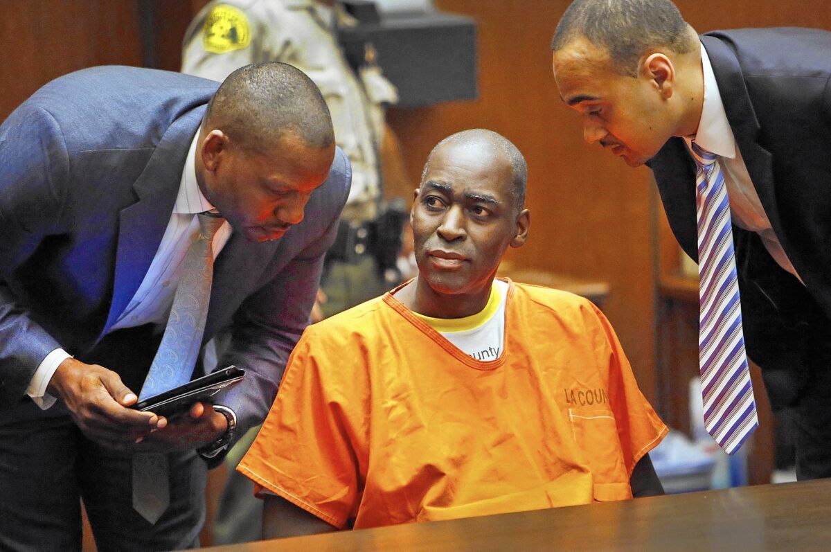 Michael Jace, charged with murder in the shooting death of his wife at their Los Angeles home, is flanked by his attorneys Peter Carr, left, and Jason Sias as he enters a not guilty plea in 2014.