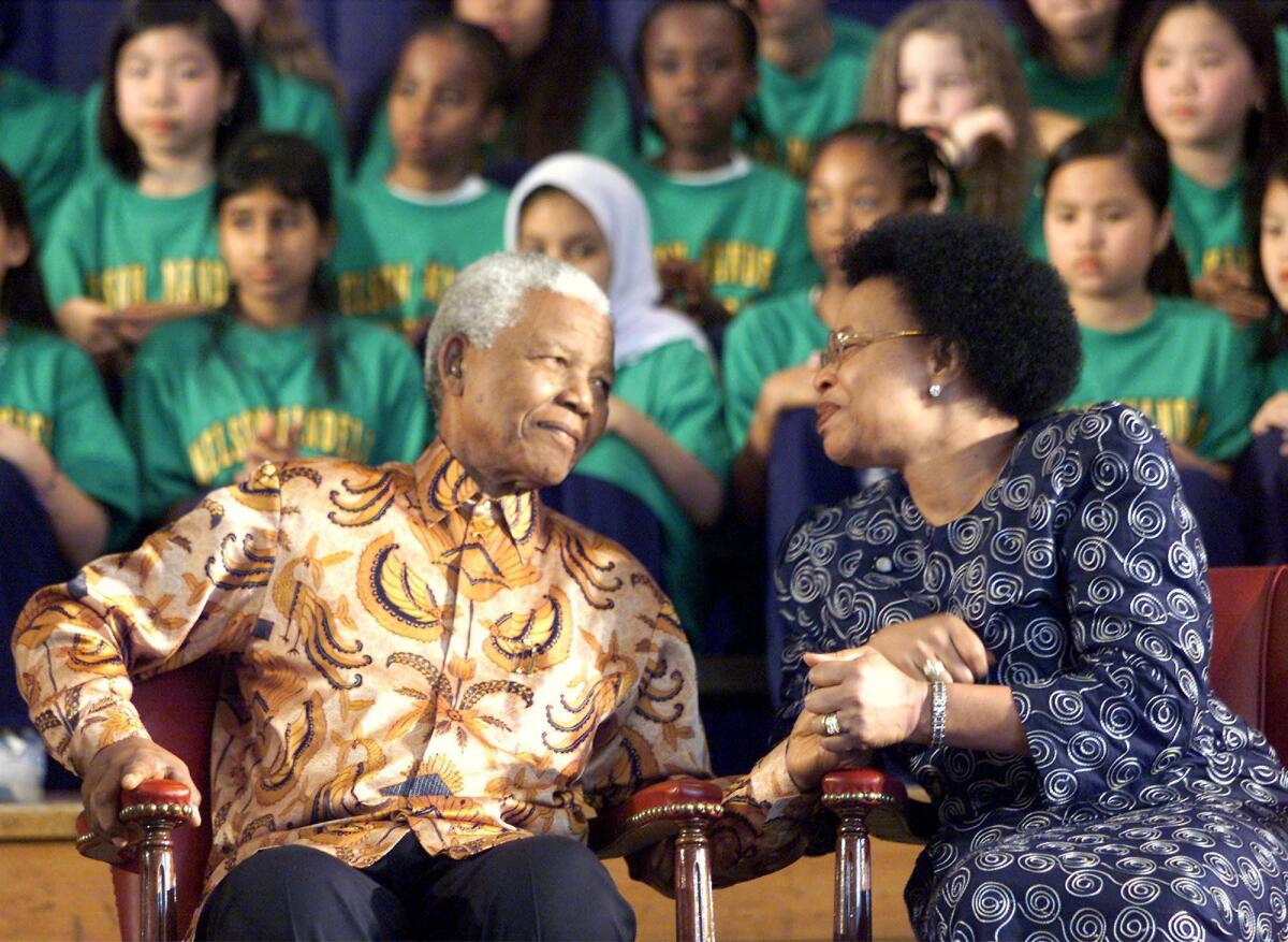 A file photo shows Nelson Mandela and his wife Graca Machel in Toronto in 2001 during a ceremony to name a school after him.