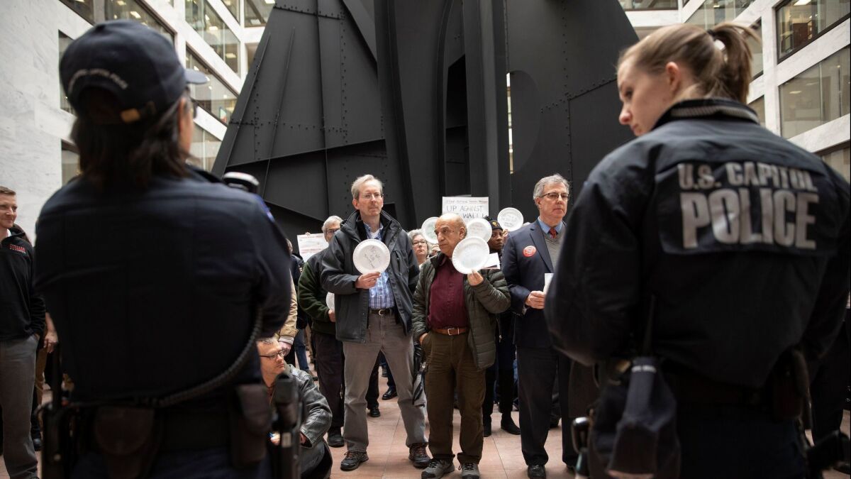 People participate in the 'Occupy Hart' protest against the partial government shutdown at the Hart Senate Office Building in Washington on Jan. 23.